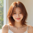 여자 중단발 레이어드컷과 오렌지 브라운 염색